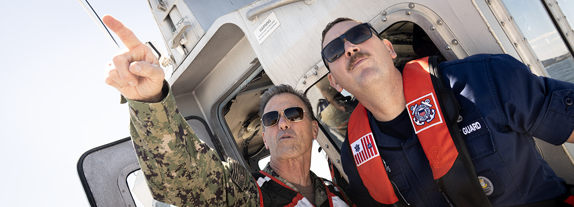 SEAC points with Coast Guardsman